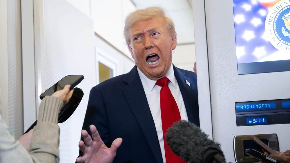 President Donald Trump speaks with the media aboard Air Force One.