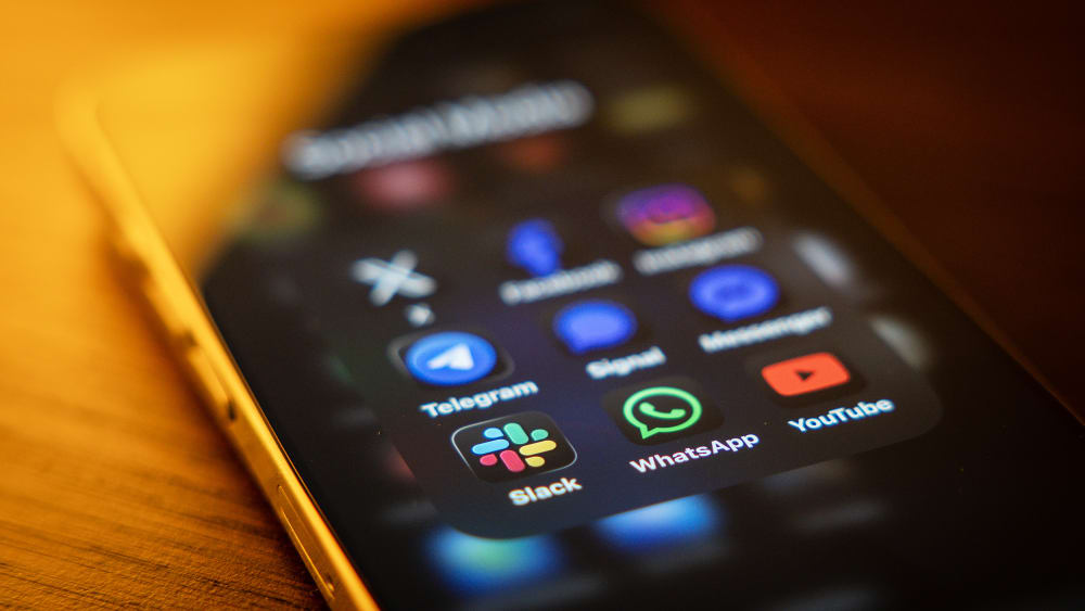 Social media and messaging apps on a mobile phone screen.