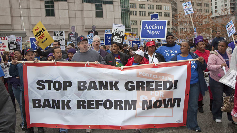 Unions, religious groups, and community organizations in Chicago rally outside the conference of the American Bankers Association.