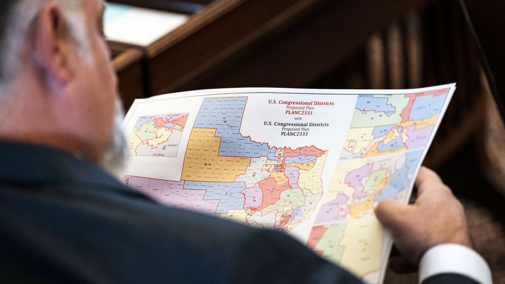 A State Representative reviews a map of proposed Texas congressional redistricting.