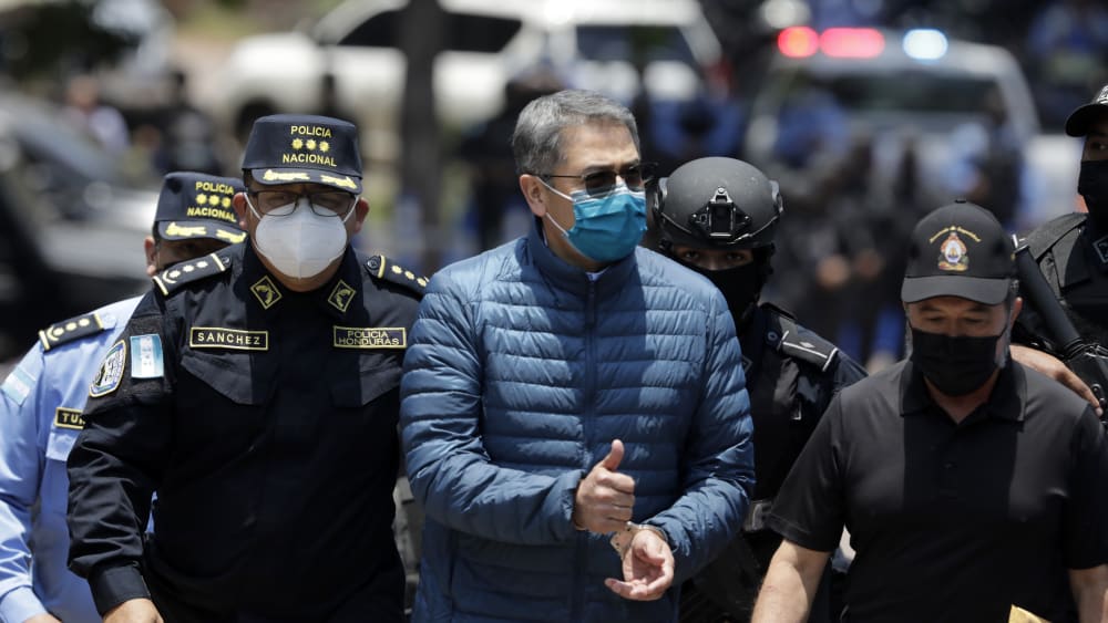 Former President of Honduras Juan Orlando Hernandez is escorted by the police to be extradited to U.S.to face charges of taking bribes from drug traffickers at Honduran National Directorate of Special Forces on April 21, 2022, in Tegucigalpa, Honduras.