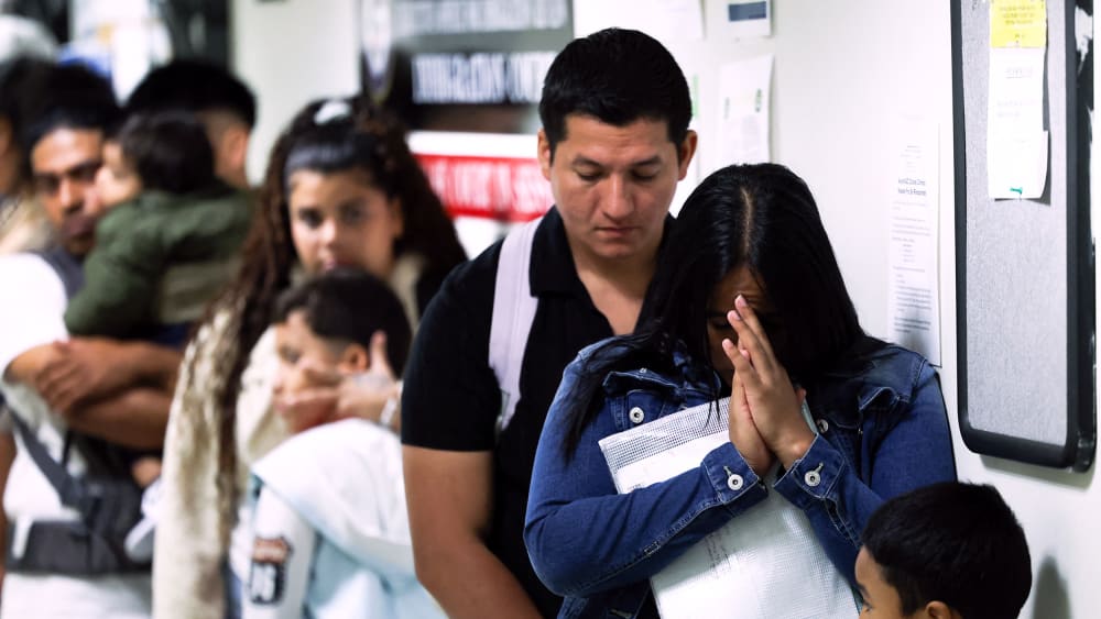 People wait in line before their hearings at the New York Federal Plaza Immigration Court in New York City.