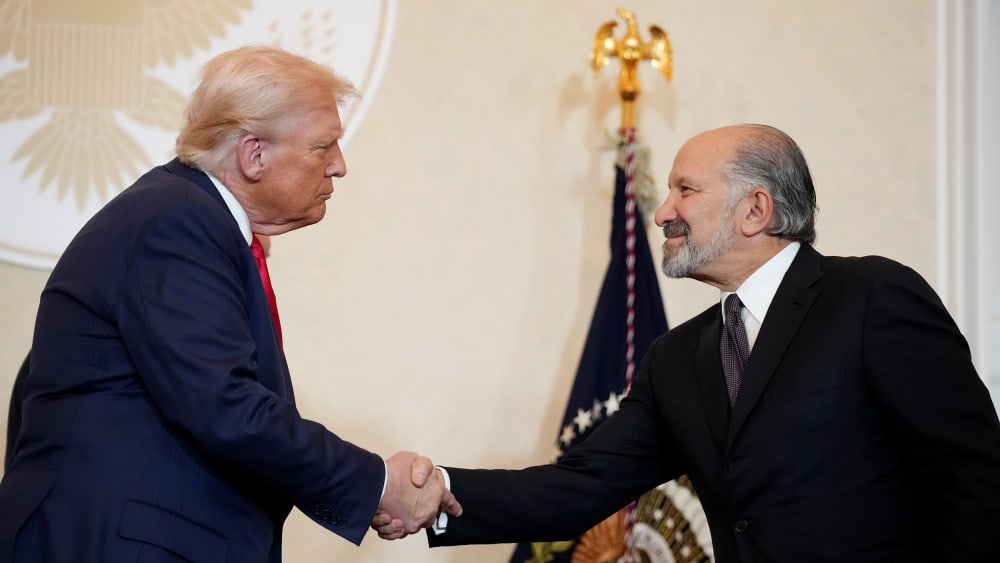 President Donald Trump shakes hands with Secretary of Commerce Howard Lutnick in Tokyo, Japan.