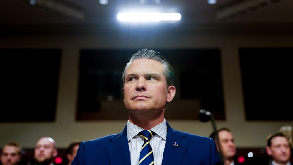 A light shines above Pete Hegseth, US secretary of defense, during a Senate Armed Services Committee hearing in Washington, D.C.