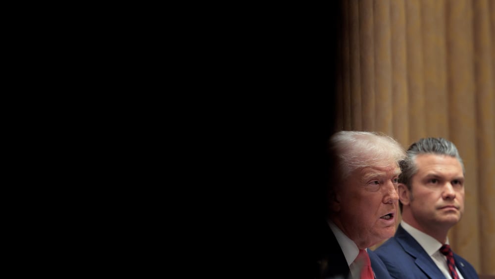 Donald Trump and Pete Hegseth sit in a Cabinet meeting