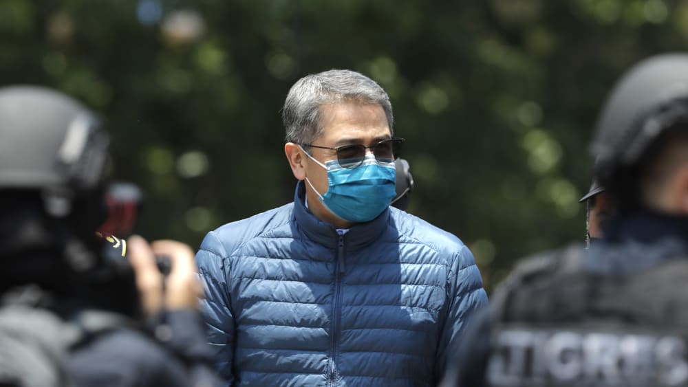 Former President of Honduras Juan Orlando Hernandez is escorted by Members of the Police Special Forces to be extradited to the U.S. to face charges of taking bribes from drug traffickers at Honduran National Directorate of Special Forces on April 21, 2022, in Tegucigalpa, Honduras.