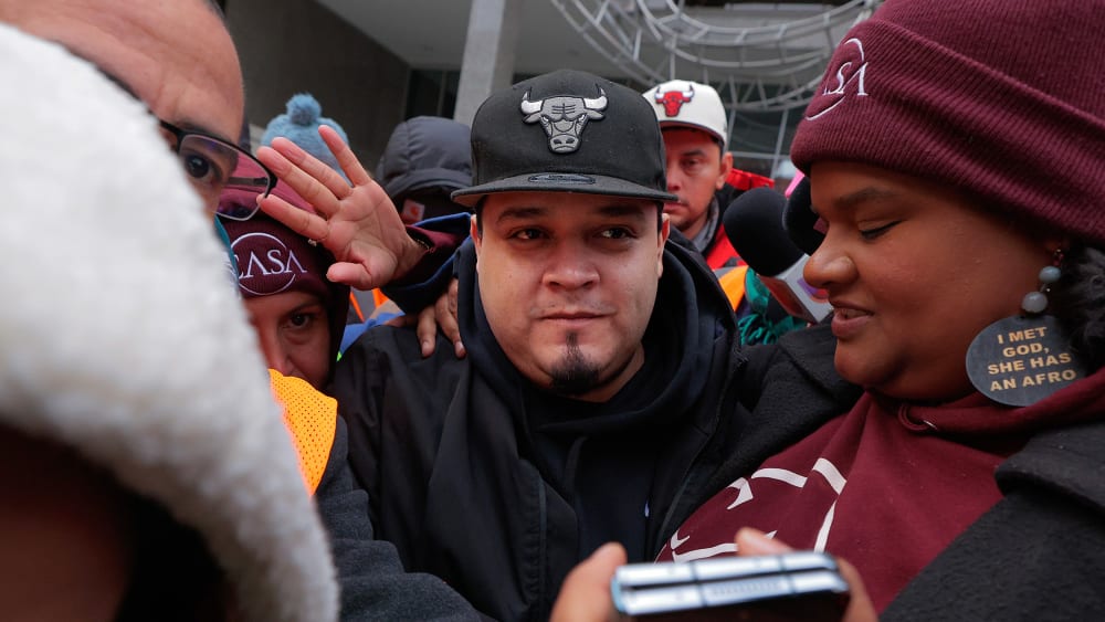 Kilmar Abrego Garcia surrounded by people at the U.S. Immigration and Customs Enforcement Baltimore Field Office.