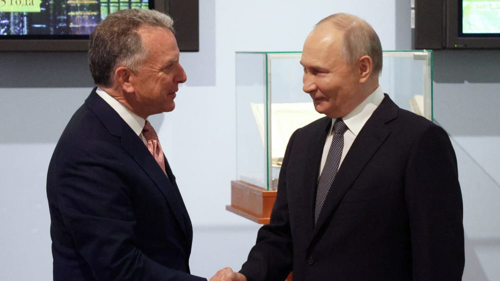 Russia's President Vladimir Putin shakes hands with US President Donald Trump's envoy Steve Witkoff.