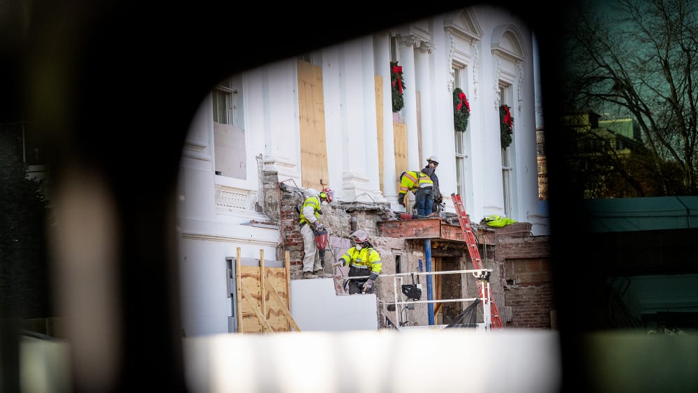 Construction workers take down material where the East Wing used to connect to the White House on Dec. 1.