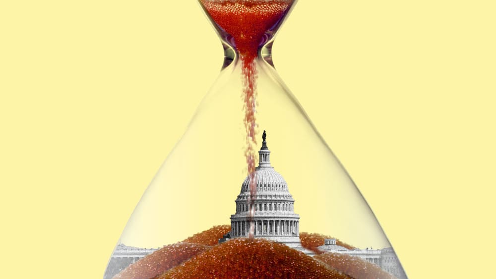 a photo illustration of the US capitol at the bottom of a nearly expired hourglass