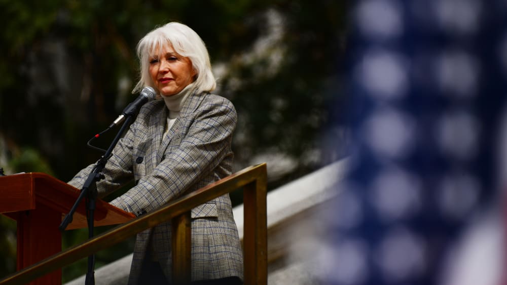 Tina Peters is in the rally in front of the Colorado State Capitol building in Denver.