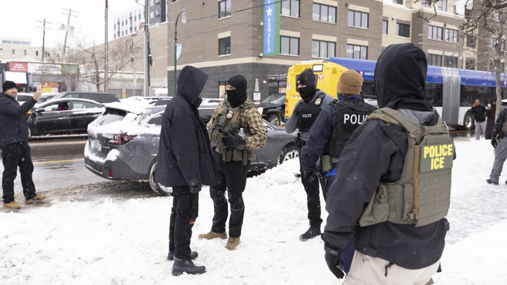 ICE officers question a man's status on Lake Street near a Somali mall called the Karmel Mall in Minnesota.