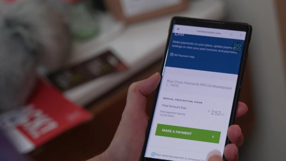 A cell phone health insurance app shows a bill