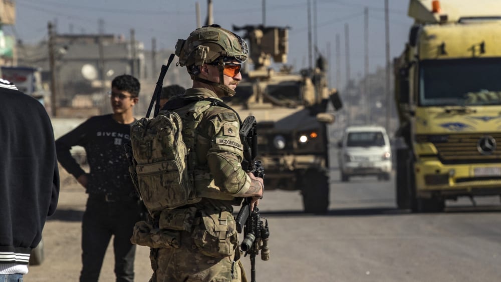 A US soldier keeps watch during a patrol in Syria.