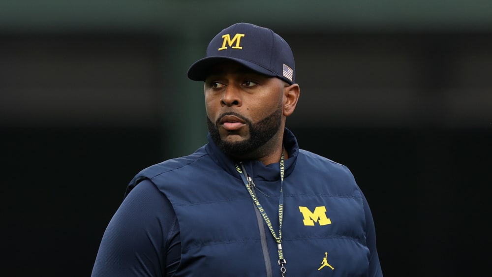 Former University of Michigan Sherrone Moore of the Michigan Wolverines observes practice prior to a game.