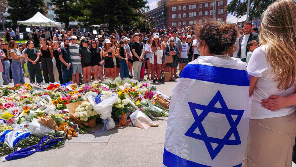 People gather at a memorial outside the Bondi Pavilion to mourn those killed in a mass shooting attack in Sydney.