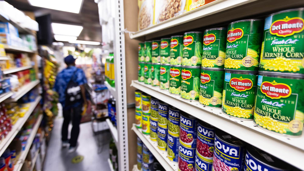 Canned food and other products in an aisle at a grocery store in NY