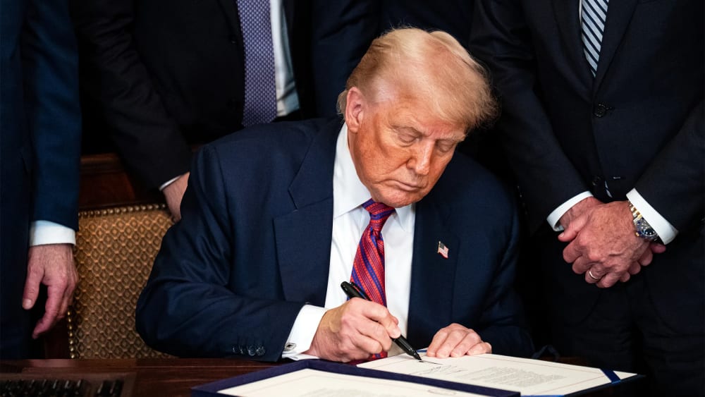 President Donald Trump signing an act on July 18, 2025, during a ceremony in the East Room of the White House.