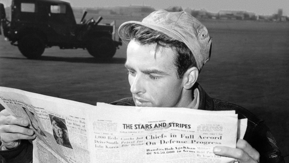 American actor Montgomery Clift reading a copy of 'The Stars and Stripes' in Berlin circa 1950.