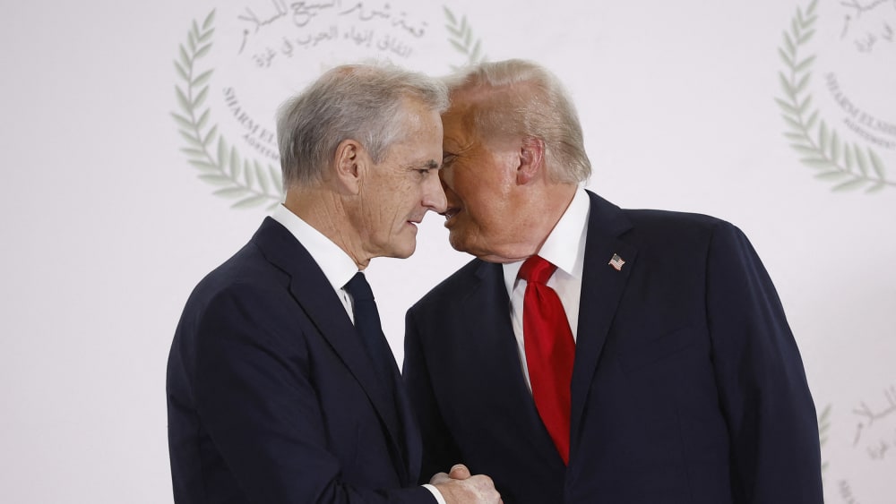 Jonas Gahr Store, left, is shaking Donald Trump's hand with Trump's face behind Store's.