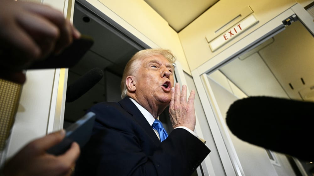 President Donald Trump speaks to the press on March 28, 2025, aboard Air Force One before arriving in West Palm Beach, Fla.