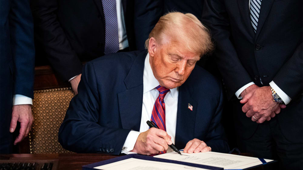 President Donald Trump signing an act on July 18, 2025, during a ceremony in the East Room of the White House.