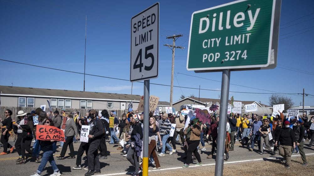 DILLEY, TEXAS - JANUARY 28: People protest against Immigration and Customs Enforcement as they march toward the South Texas Family Residential Center on January 28, 2026 in Dilley, Texas. A federal judge temporarily blocked the deportation of 5-year-old Liam Conejo Ramos and his father, Adrian Conejo Arias, who were arrested in Minneapolis after the father had picked the boy up from school. They were then taken to the South Texas Family Residential Center, an immigration detention center outside San Antonio, where they remain. (Photo by Joel Angel Juarez/Getty Images)