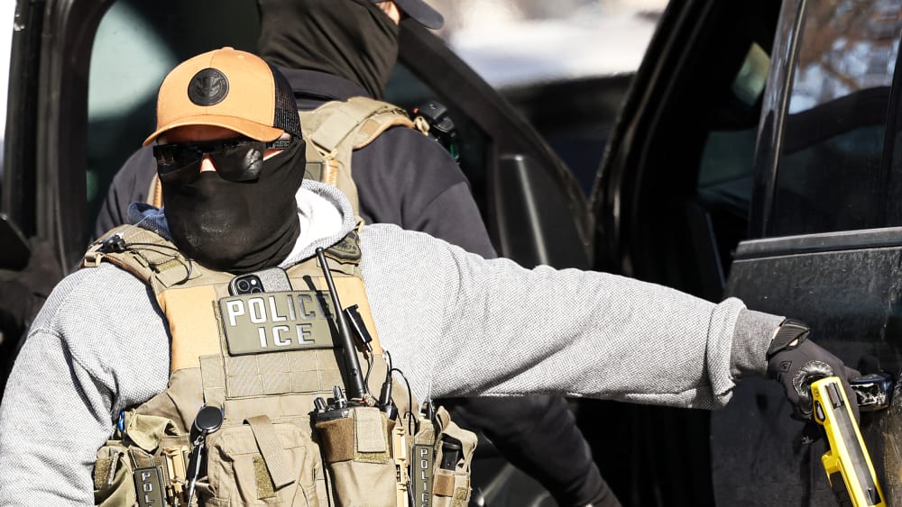ICE agent stands by a vehicle on Feb. 3, 2026 after they detained a protester in Minneapolis.