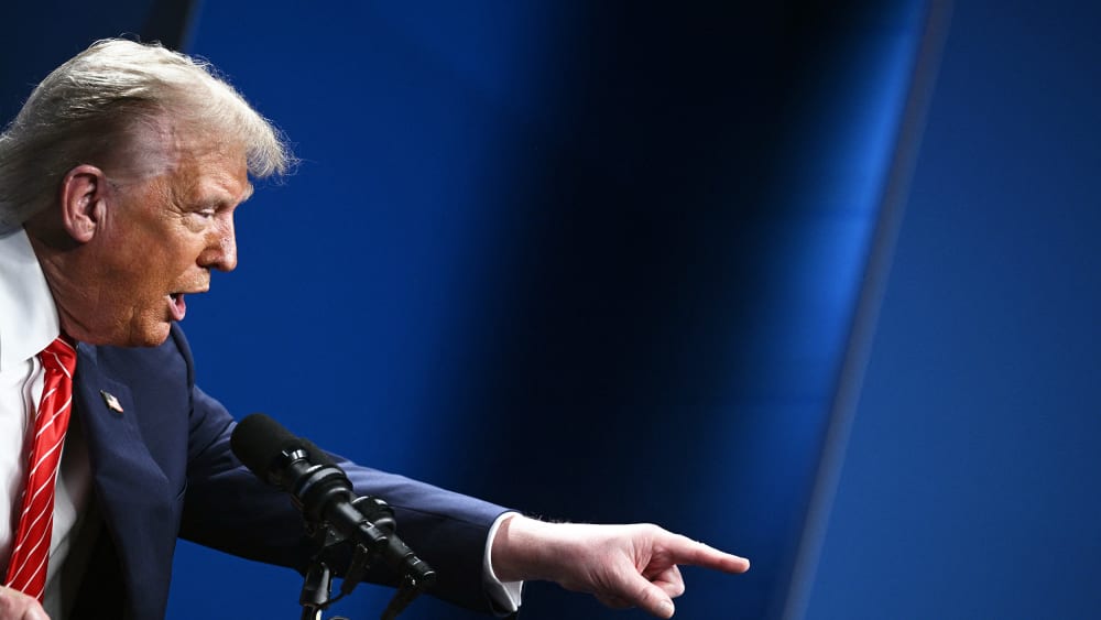 President Donald Trump gestures as he gives a press conference.