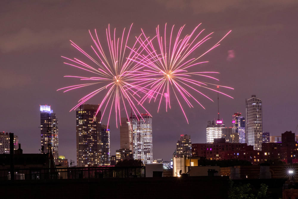 Image: Illegal fireworks illuminate the sky over the Bedford-Stuyvesant neighborhood of the Brooklyn borough of New York City, New York