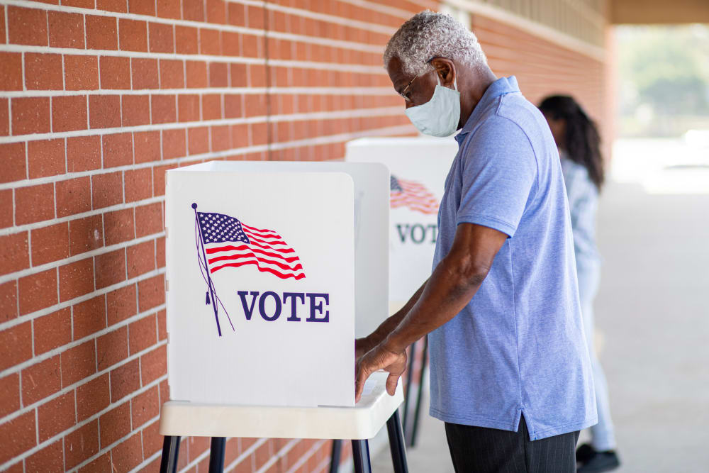 Senior Black Man Voting with a Mask