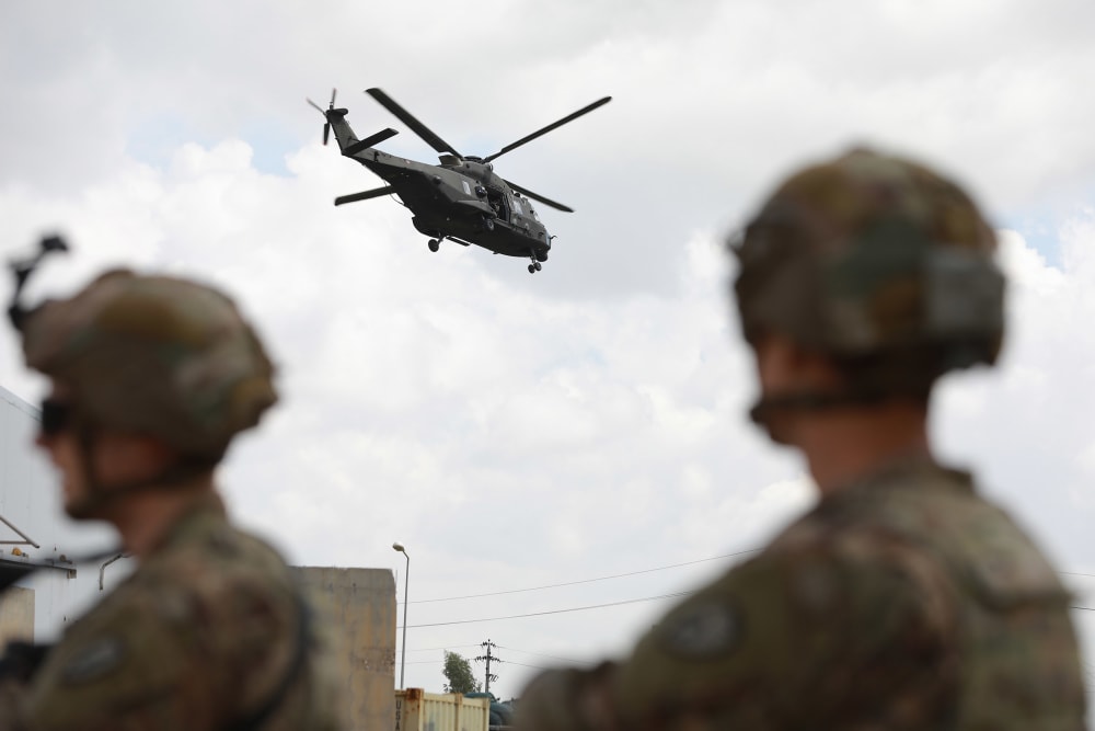 Image: U.S. soldiers stand guard at the K1 Air Base near Kirkuk in northern Iraq, during its handover ceremony