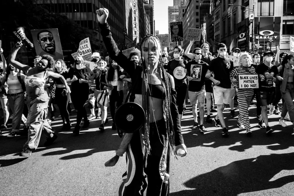 Image: Livia Johnson, an organizer with Warriors in the Garden, raises her fist as she marches with protesters through New York's Times Square on June 14, 2020.