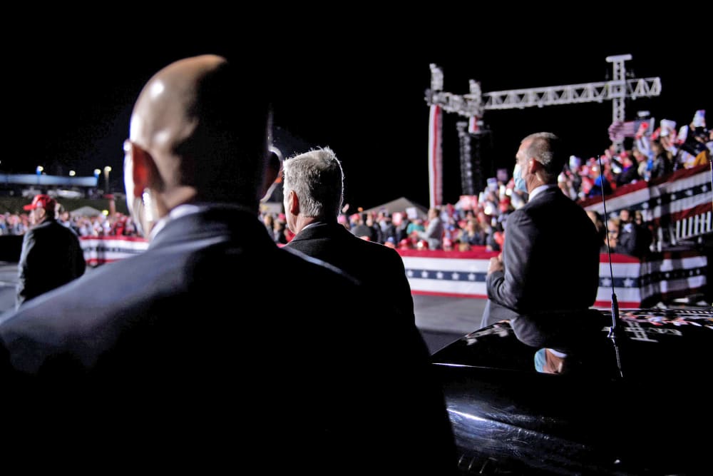 Secret Service members and others listen while President Donald Trump speaks in Hickory, N.C., on Nov. 1, 2020.