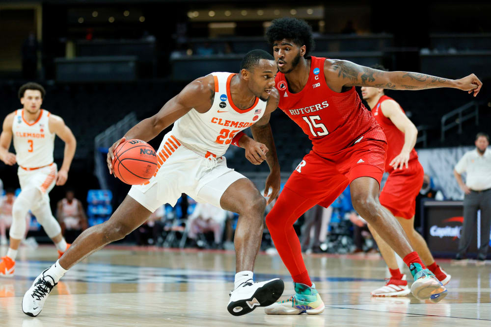 Aamir Simms #25 of the Clemson Tigers handles the ball in the first half against Myles Johnson #15 of the Rutgers Scarlet Knights on March 19, 2021, in Indianapolis.
