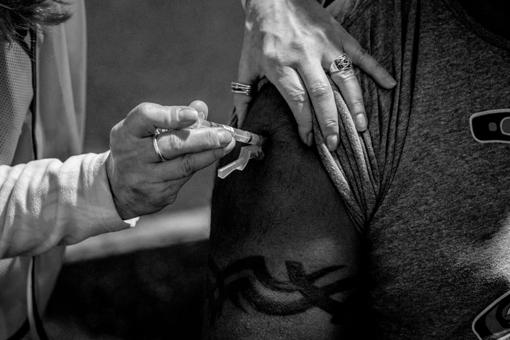 Image: A patient receives a Covid-19 vaccine in Federal Way, Wash., on Feb. 4, 2021.
