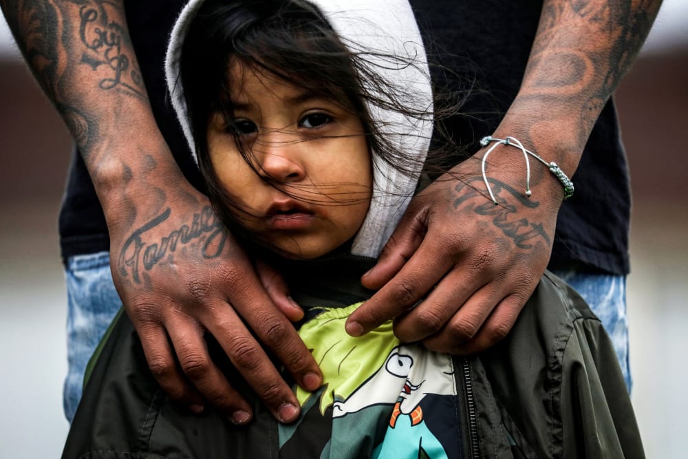 Image: Jose Chavez wraps his arms around his daughter, Cattleya Chavez, 3, at a protest outside the Brooklyn Center Police Department in Minnesota on April 13, 2021.