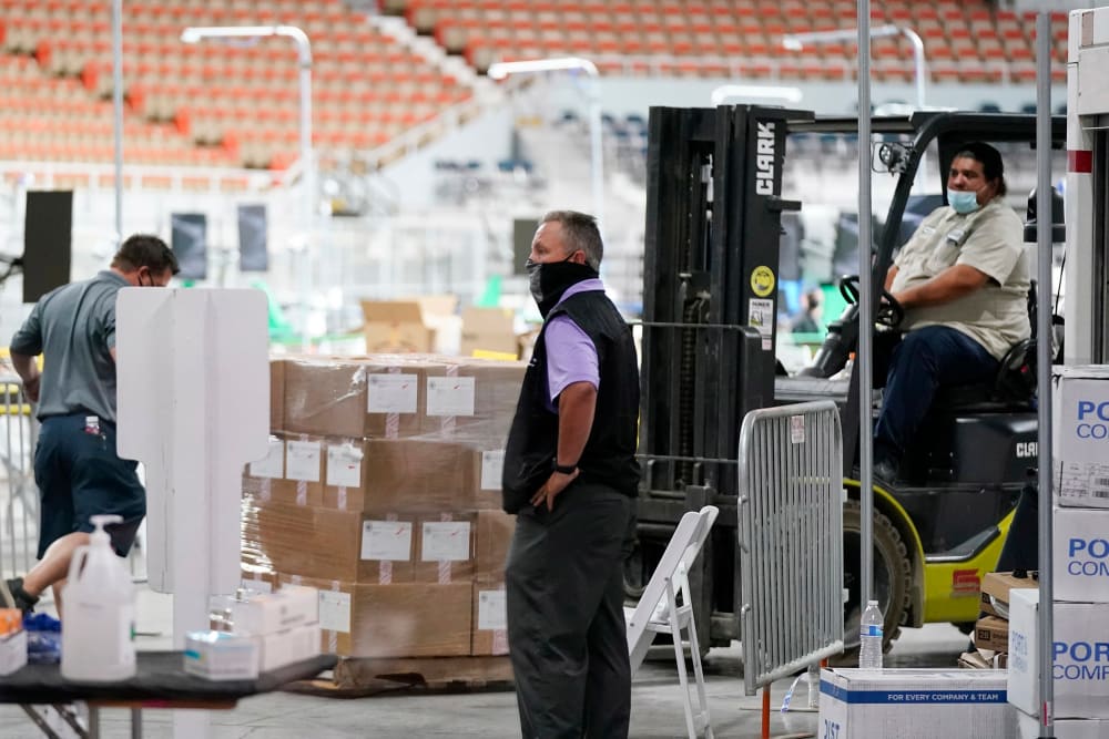 Image: Some of the 2.1 million ballots cast during the 2020 election, are brought in for recounting at a 2020 election ballot audit ordered by the Republican lead Arizona Senate at the Arizona Veterans Memorial Coliseum