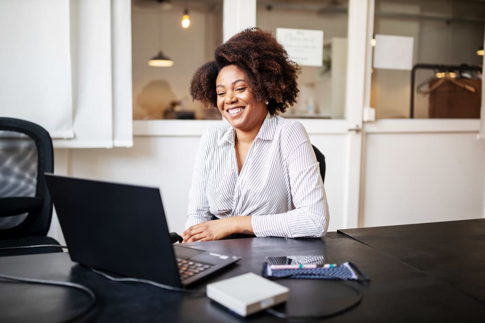 Businessman sitting in office smiling during a video call