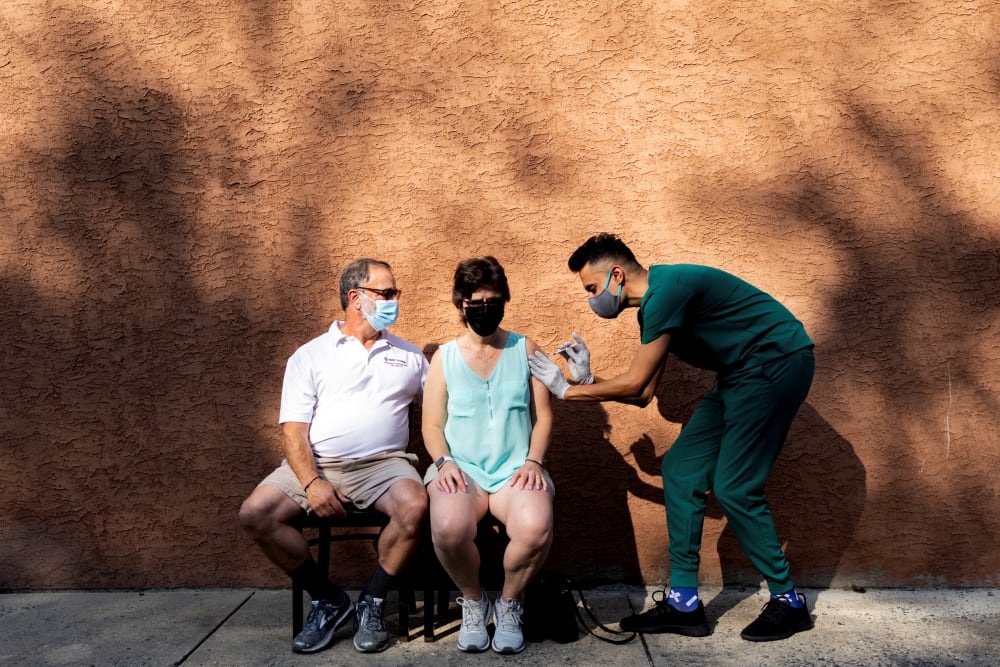 IMAGE: A woman receives a booster dose of the Pfizer-BioNTech Covid-19 vaccine at a pharmacy in Schwenksville, Pa., on Aug. 14, 2021.
