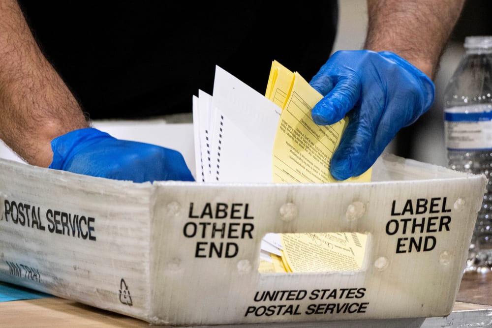 Fulton County Georgia elections workers process absentee ballots for the Senate runoff election in Atlanta on Jan. 5, 2021.