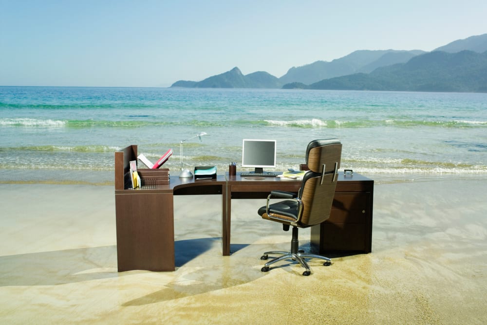 Office desk on beach.