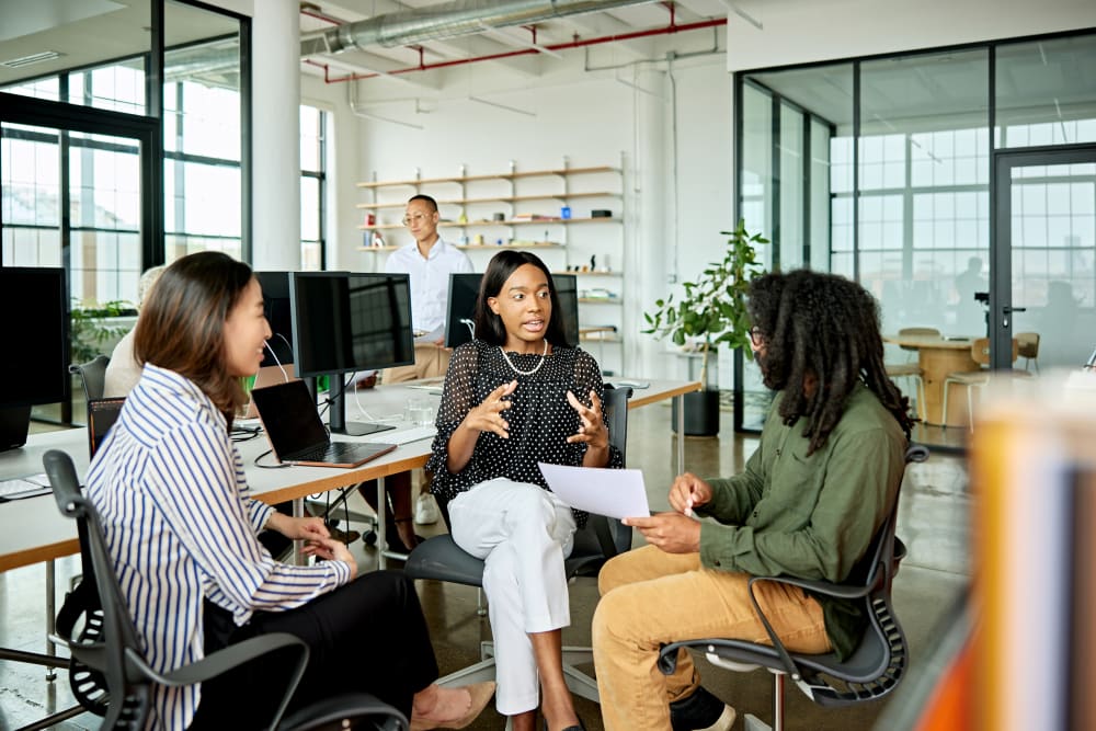 Three creative colleagues exchanging ideas