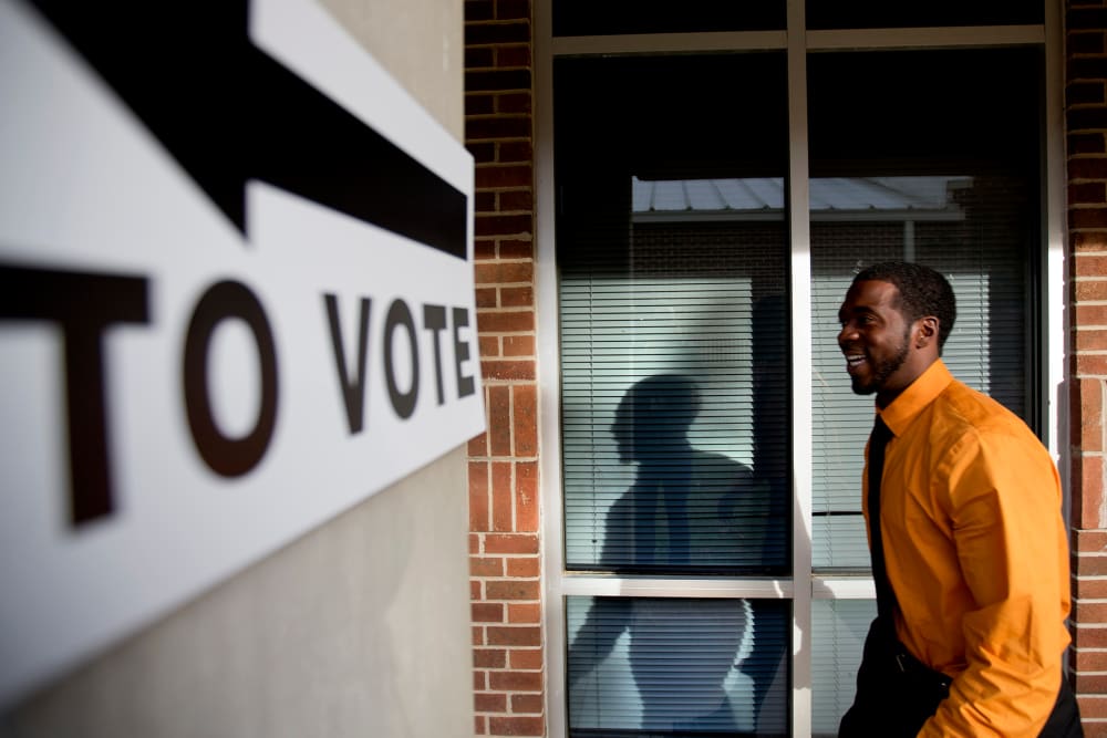Jovan Steele, of Atlanta, enters a polling station to vote, Tuesday, Nov. 5, 2013.