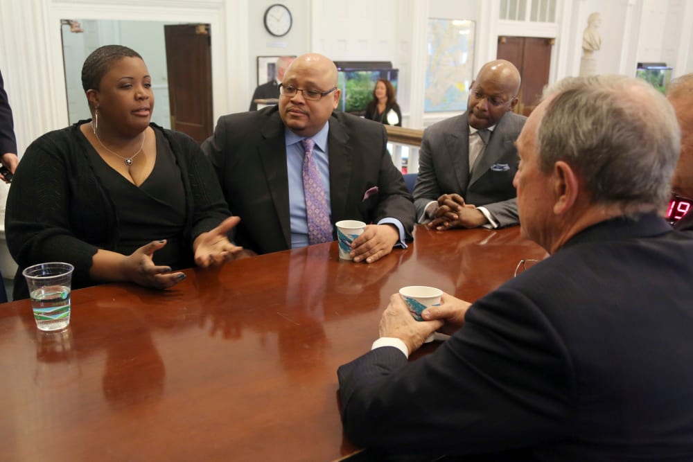 New York City Mayor Michael Bloomberg, foreground, meets with Cleopatra Cowley-Pendleton, left, and Nathaniel A. Pendleton Sr., center, and Van Vincent, Thursday, April 4, 2013 at City Hall in New York. The Pendletons are the parents of Hadiya...