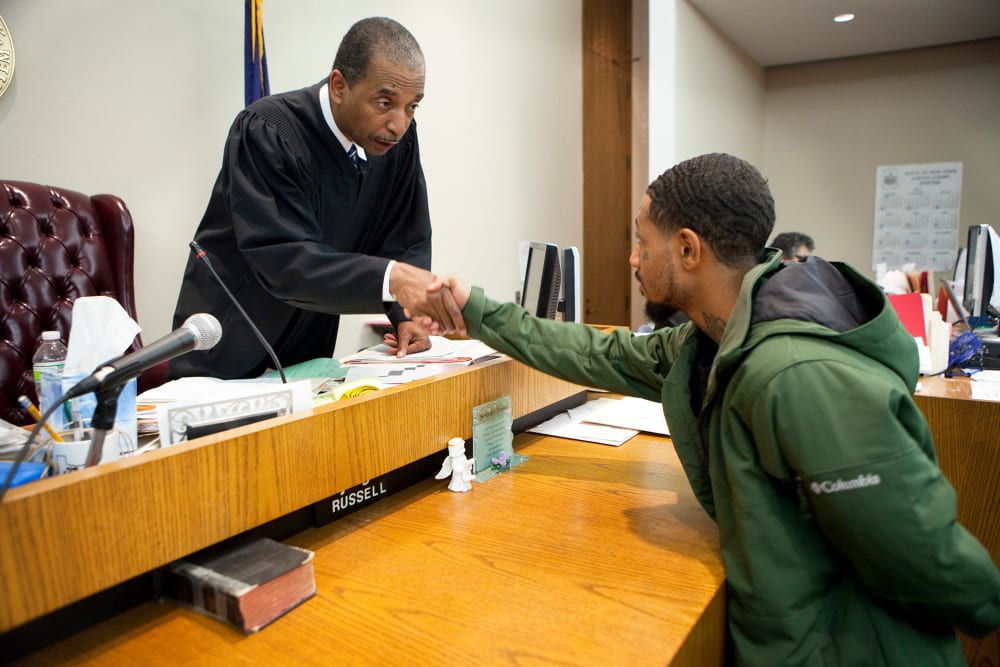 Judge Robert Russell, creator of the Buffalo Veterans Treatment Court, shakes hands with veteran Justin Smith who has succeeded in his court, on Oct. 23, 2012.