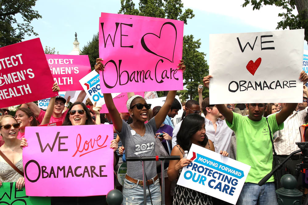Obamacare supporters react to the U.S. Supreme Court decision to uphold President Obama's health care law, on June 28, 2012 in Washington, D.C.