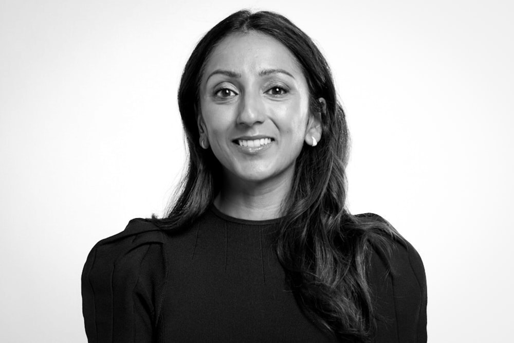 Amy Jain smiles, black and white photo