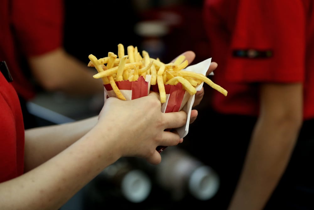 An employee collects two portions of french fries for a customer inside a Burger King restaurant. (Photo by Andrey Rudakov/Bloomberg/Getty)