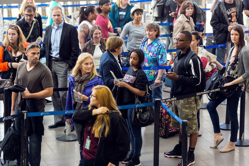 Travelers in line at Los Angeles International airport Monday, April 22, 2013. (AP Photo/Damian Dovarganes)